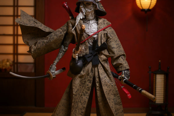 1/12 scale action figure wearing a dark fabric samurai robe, posed in a Japanese dojo setting with tatami, katana stand, and paper lantern, against a crimson and gold gradient background.