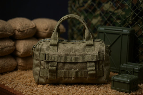 1/12 scale fabric tactical duffel bag with olive drab canvas texture on a sandbag barricade with camouflage netting and ammo crates, dramatic lighting, bold colors.