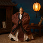 Traditional Chinese scholar robe with wire-framed sleeves on action figure, with pavilion and desk props, teal and crimson background.