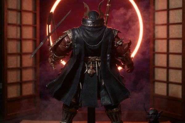 Dark flowing 1/10 scale fabric cape with wire-shaped folds displayed on a wooden stand beside a katana and oni mask, against a crimson-violet gradient folding screen with fog and ring light.