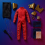 Miniature dark navy fabric body suit with visible wire framework and bronze armor pieces on electric blue to magenta gradient background