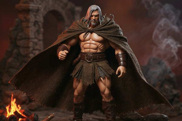 Brown/tan weathered fabric cape with frayed hem and tie front draped over a muscular 6-inch barbarian action figure on a rocky diorama with ancient ruins and campfire, dynamic windswept pose.