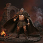 Brown/tan weathered fabric cape with frayed hem and tie front draped over a muscular 6-inch barbarian action figure on a rocky diorama with ancient ruins and campfire, dynamic windswept pose.